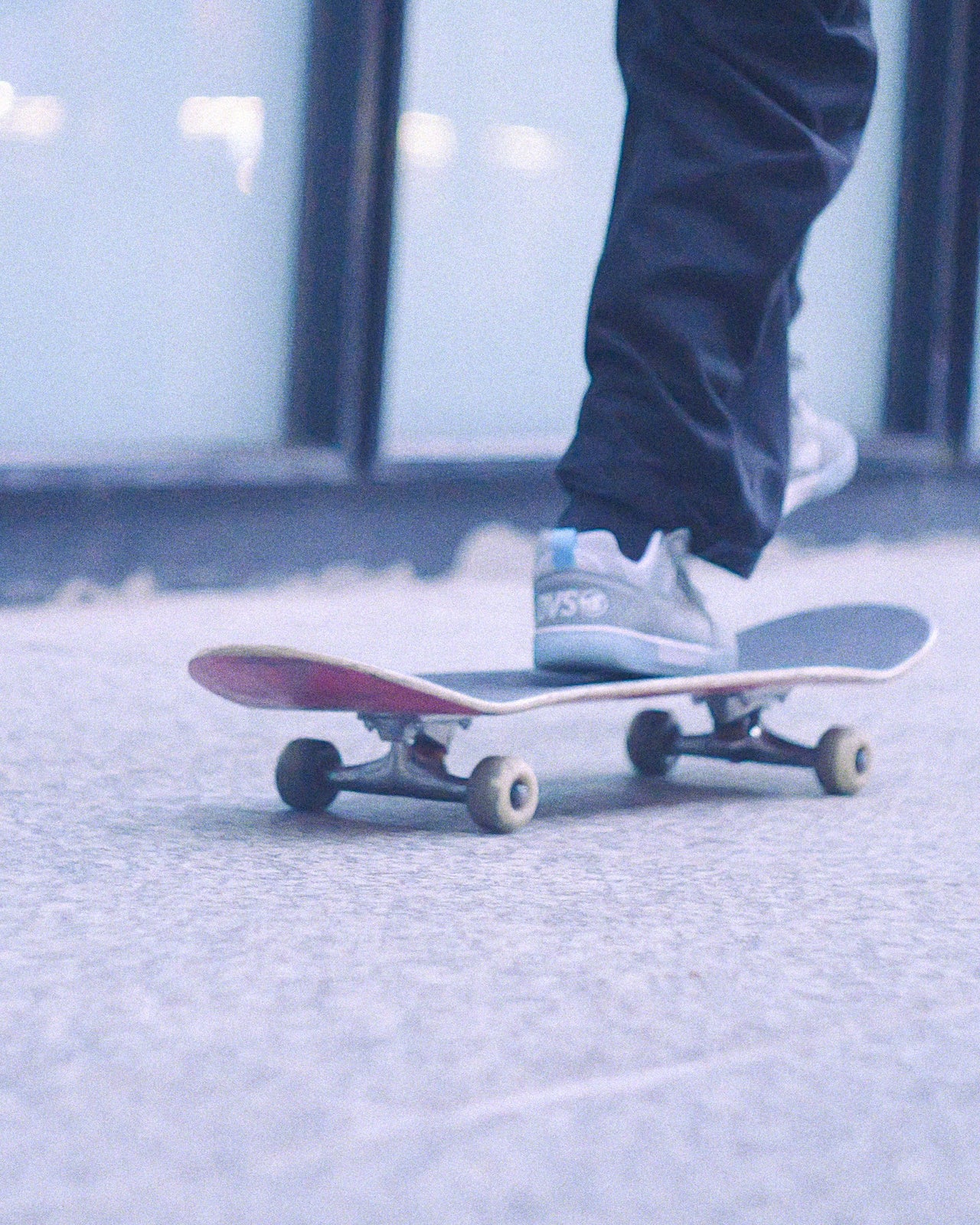 Person standing on a skateboard with blurred background