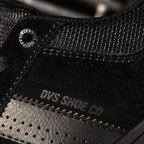 Close-up of a black sneaker with 'DVS Shoe Co' branding on the side.