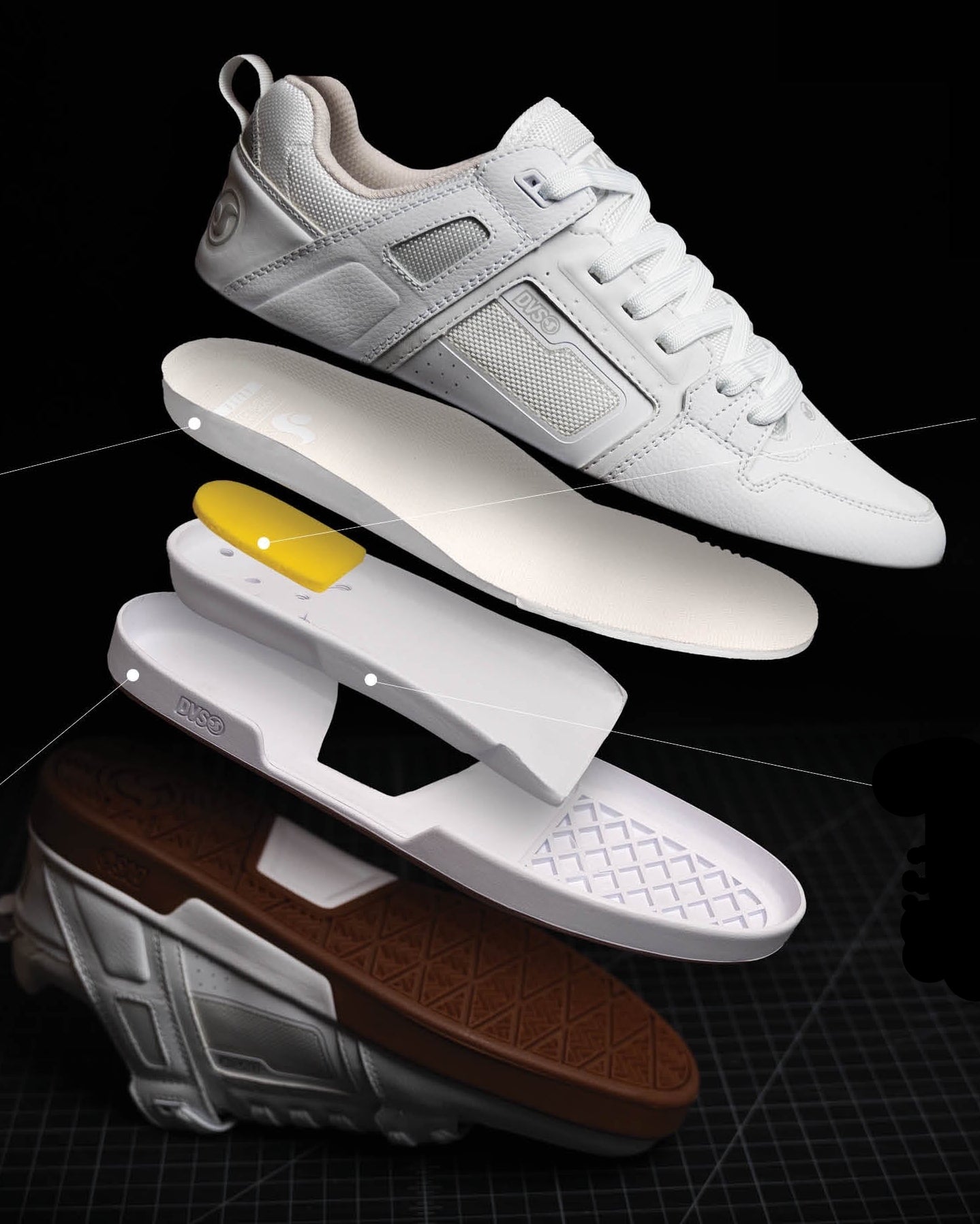 White sneaker with technical details on a black background