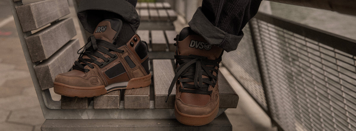Brown boots with visible brand name on a concrete surface
